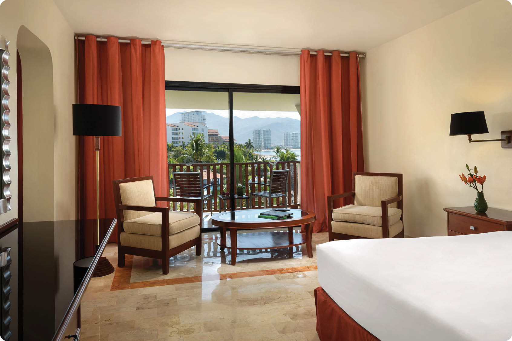 A hotel room with a large bed, a chair, and a couch. The room has a large window with a view of the city. AI generated content