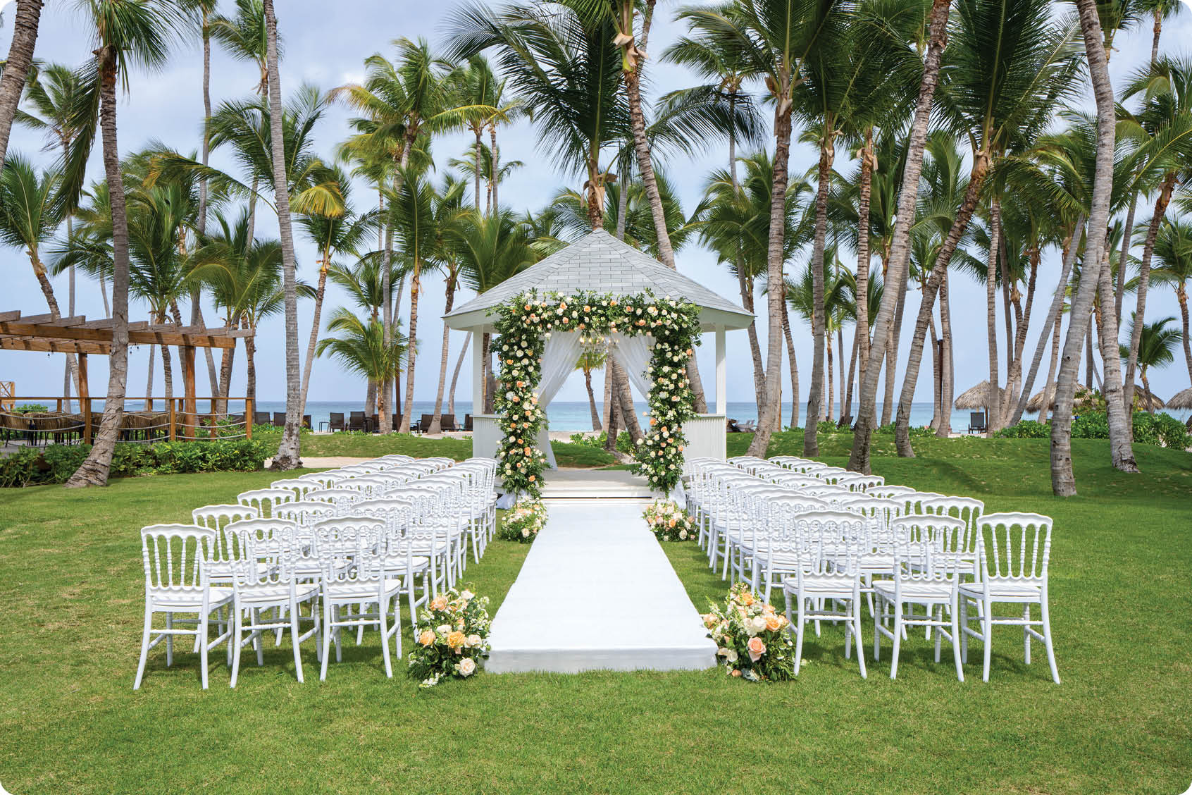 A white wedding arch with a flower arrangement in front of it. AI generated content