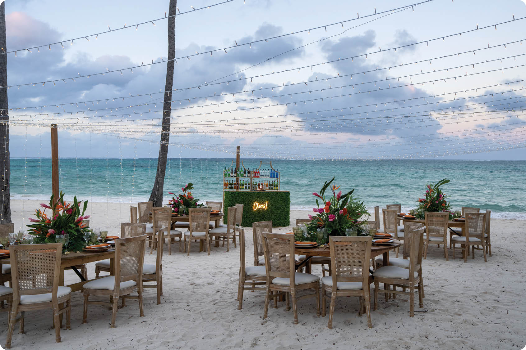 A beach setting with a table and chairs. AI generated content
